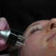 Professional facial skin tightening treatment with handheld device