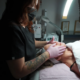 Professional esthetician performing facial massage skincare treatment
